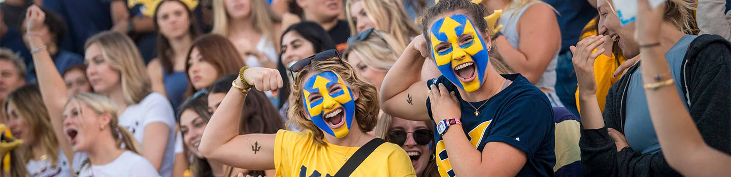 A large crowd of happy UC San Diego students cheer and celebrate at a home water polo game - photo by Erik Jepsen