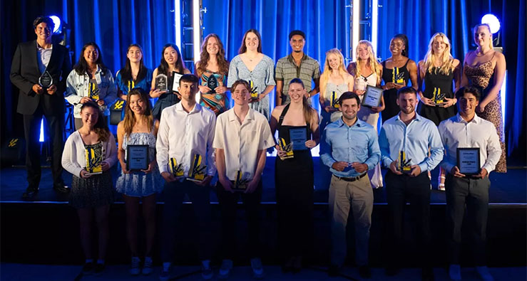 Group of smiling UCSD Triton athletes stand on stage accepting their 2025 awards