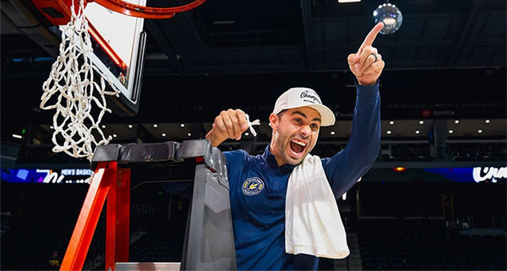 Coach Clint Allard cutting the net at The Big West Championship in March 2025