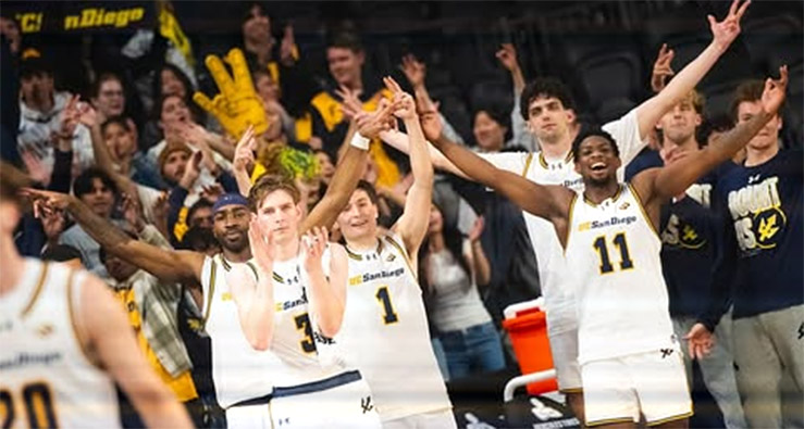 UCSD Triton basketball players celebrate on the court