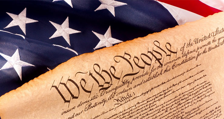 Part of a parchment - original image of the U.S. Constitution, and U.S. flag draped across the top
