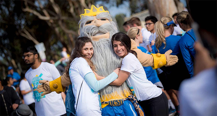 UC San Diego students hug their Triton mascot