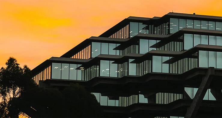 UC San Diego's Geisel Library glows against an orange sky