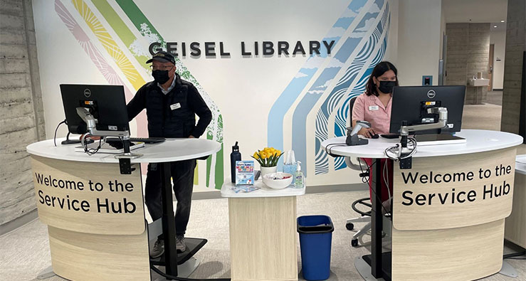 Librarians and staff stand at the ready at the Geisel Library service desk, UC San Diego