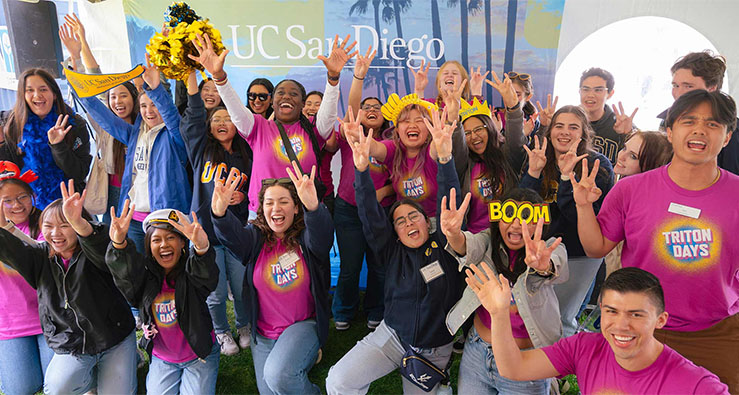 A large group of happy UCSD community members, most wearing pink TRITON DAYS t-shirts