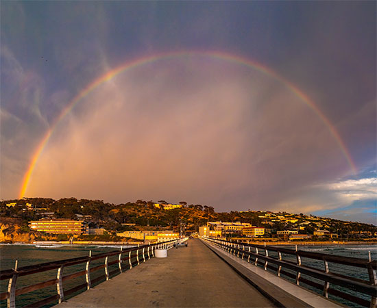 Glowing full rainbow over Scripps Pier