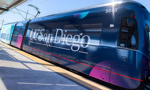 Trolley pulling into UCSD station - wrapped in UCSD graphics